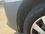 a close up of a car ' s tire on the road