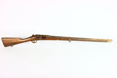 an old rifle on a white surface with a white background