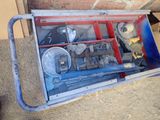 a metal box with tools in it sitting on the ground