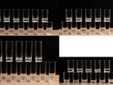 many shot glasses lined up on a shelf