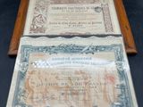 an old paper certificate with a wooden frame on a black background