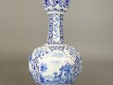 a blue and white vase sitting on a table