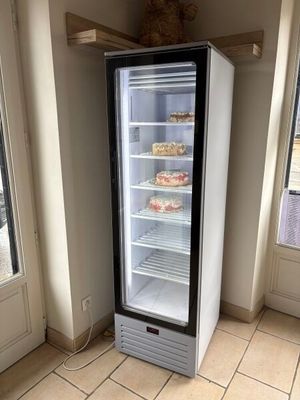 a refrigerator that is sitting in the corner of a room