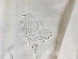 a close up of a white shirt with a bird embroidered on it