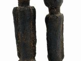 statue of a couple of people made of stone on a black base
