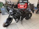 a black motorcycle that is parked in a garage