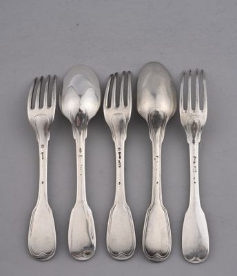 four silver spoons and a fork on a gray surface