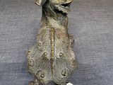 bronze statue of a dog with a hat on its head