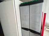 two refrigerators that are sitting next to each other in a room