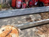 several fire extinguisors are lined up next to a concrete wall
