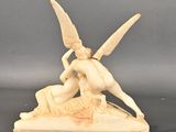 statue of a woman kneeling on a rock with a bird on her shoulder