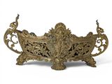 a large ornate brass planter sitting on a white surface