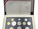 an open book with coins in it on a white surface