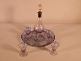 a blue and white glass decanter on a tray
