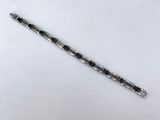 a silver and black pen sitting on top of a white table