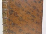 an old brown book with gold trimmings on a white background