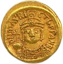 une pièce d'or à l'effigie d'un homme coiffé d'une couronne