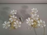 pair of white flowers with gold leaves on them on a white surface