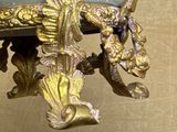 a gold and blue vase with a bird on it