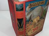 a red book with a picture of a ship on it