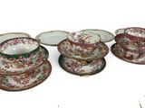 a group of plates and bowls sitting on a white surface