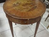 a small table with a painting on the top of it