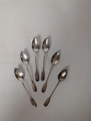 several spoons are arranged in a circle on a white surface