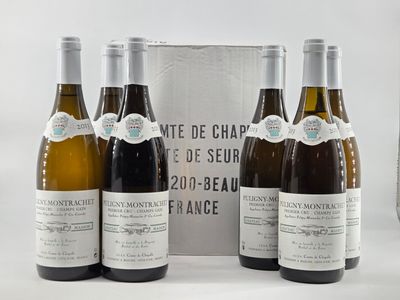 six bottles of wine are lined up in a row in front of a box