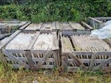 many wooden crates that are sitting in the grass