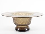 brown glass bowl sitting on top of a black base