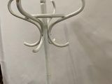 a white coat stand with a coat rack on it