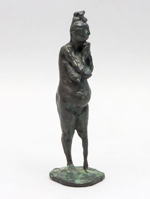 bronze statue of a woman standing on a pedestal with her hands on her hips