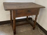 a small wooden table with a drawer underneath it