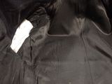a black jacket that has a white tag on it