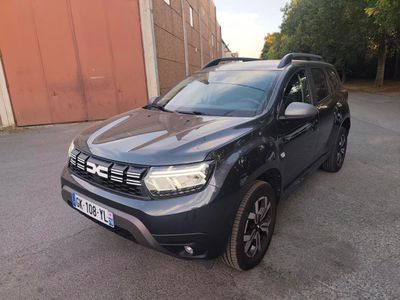 the front view of a black dacia parked in a parking lot