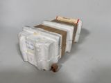 a stack of three white boxes sitting on top of a table