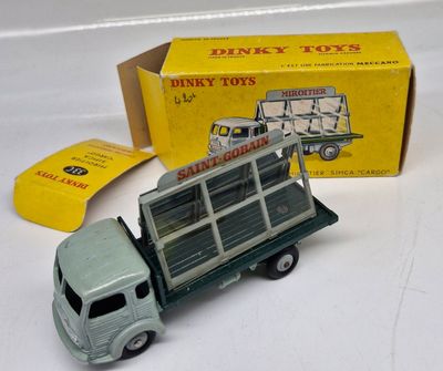 a toy truck that is sitting next to a box of dinky toys