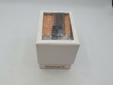 a box with a watch inside of it on a white surface