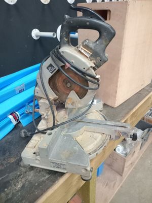 a picture of a man using a circular saw to cut a piece of wood