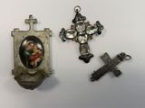 three religious items are displayed on a white surface
