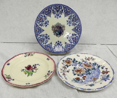 three plates with floral designs on them sitting on a table