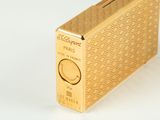 an image of a gold cigarette case sitting on top of a white table
