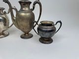 three silver vases sitting next to each other on a table