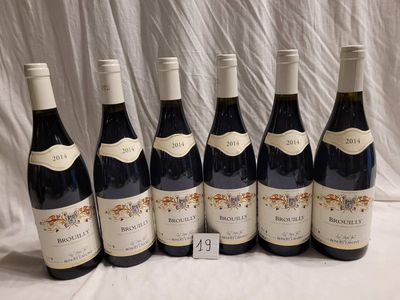 six bottles of wine are lined up on a table