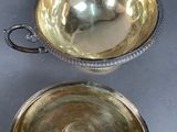 pair of silver plated bowls with handles and handles