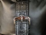 an image of a close up of a bag with a watch on it