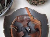 two helmets on a table next to a pair of shoes
