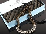 a close up of a box with a necklace in it on a table