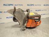 a close up of a chainsaw on a table in front of a wall