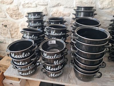 many pots and pans that are on a table